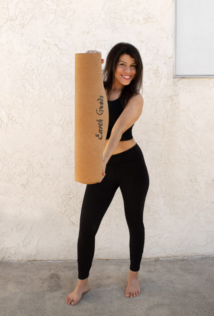 Model displaying Earth Goods eco friendly cork yoga mat